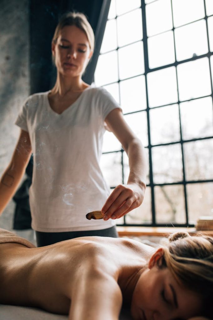 Peaceful indoor spa massage with aromatherapy, promoting relaxation and self-care.
